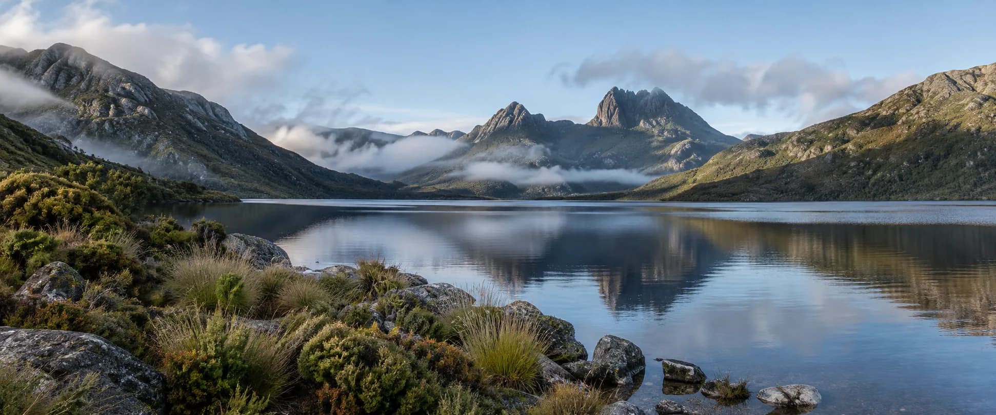 A calm alpine lake below rugged mountains in Tasmania